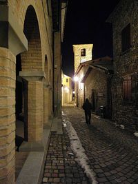 People in illuminated city at night