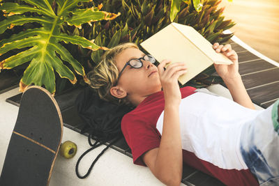 Midsection of woman sitting on book