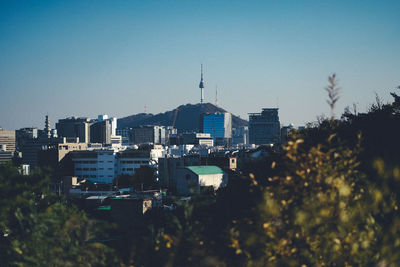 High angle view of buildings against clear blue sky