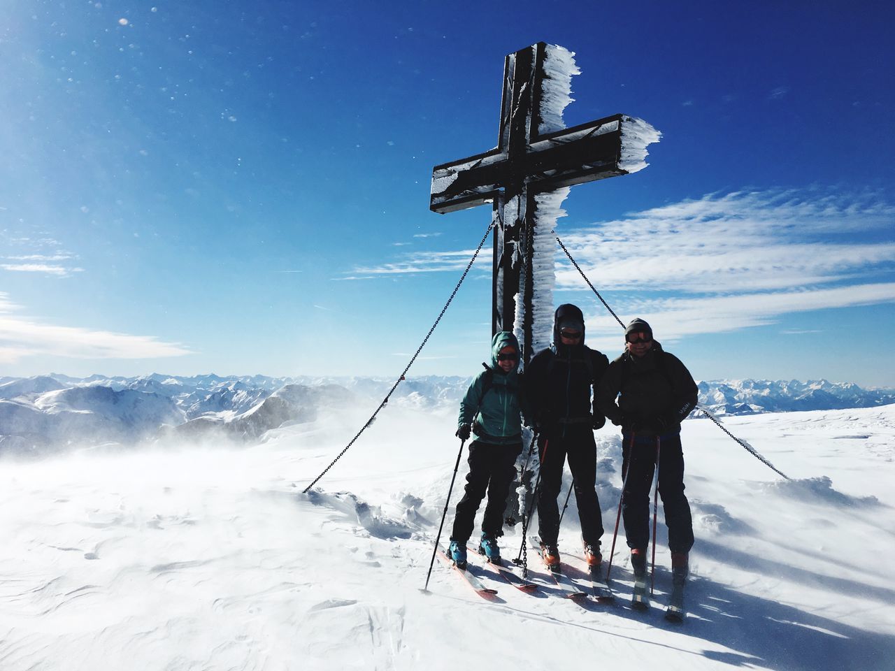 PEOPLE ON SNOWCAPPED MOUNTAINS AGAINST SKY