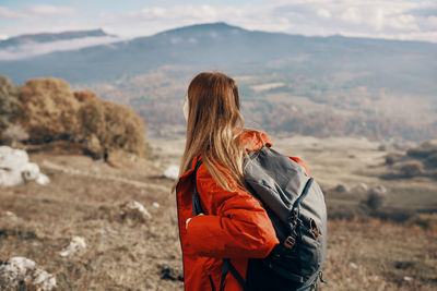 Side view of woman looking at mountain range