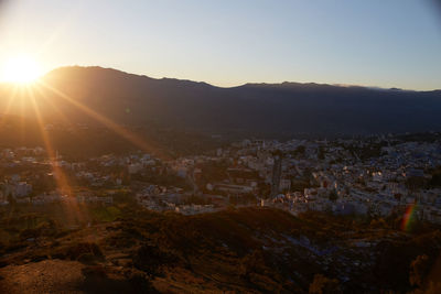 Aerial view of townscape against sky at sunset