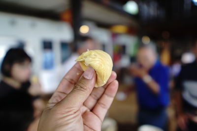 Yellow durian fruit on your fingers