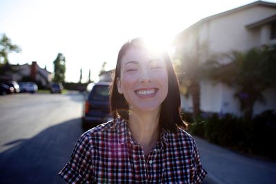 Close-up portrait of a happy young woman outdoors