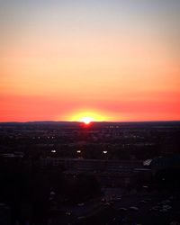 Aerial view of cityscape against sky during sunset