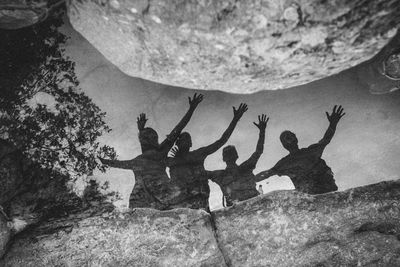 High angle view of friends reflecting in puddle