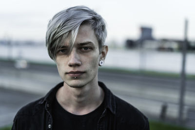 Portrait of confident young man outdoors