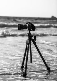 Close-up of camera photographing on beach