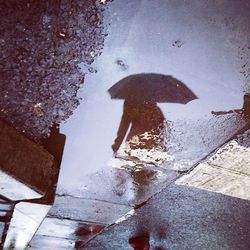 Reflection of building in puddle