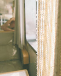 Close-up of curtain on glass window