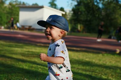 Cheerful boy running outdoors