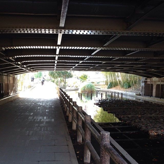 the way forward, built structure, architecture, diminishing perspective, ceiling, indoors, incidental people, vanishing point, walkway, pedestrian walkway, transportation, walking, architectural column, sunlight, arch, cobblestone, in a row, footpath, building exterior