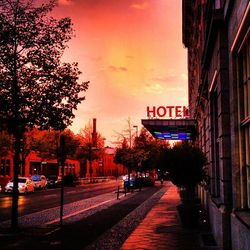 Road sign in city at sunset