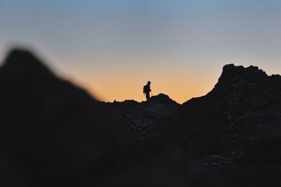 Low angle view of man standing on rock formation
