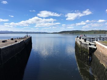 Pier over river against sky