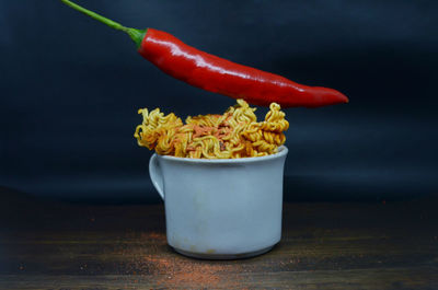 Close-up of red chili peppers in bowl on table