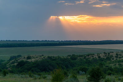 Scenic view of field against sky during sunset