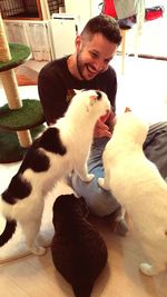 Young man with cat at home