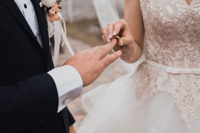 Midsection of bride holding hands