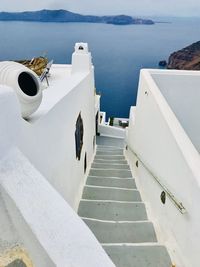 High angle view of steps amidst sea against sky