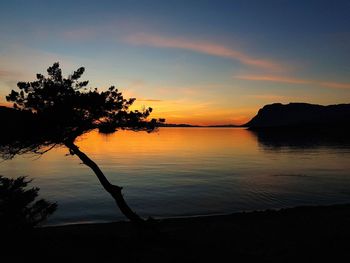 Scenic view of lake against orange sky