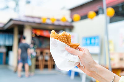 Cropped hand of person holding ice cream cone