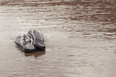 High angle view of shoes on beach