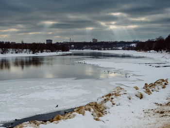 Scenic view of frozen lake against sky during winter