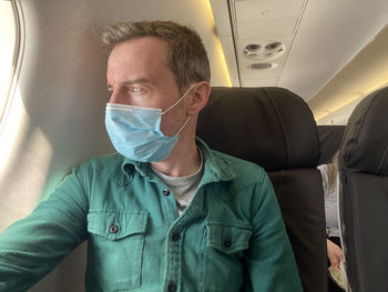 Portrait of man sitting in airplane