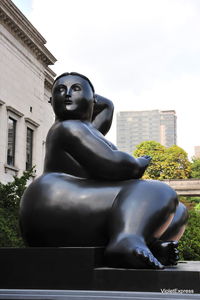 Low angle view of statue against building in city