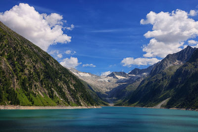 Scenic view of lake and mountains against sky