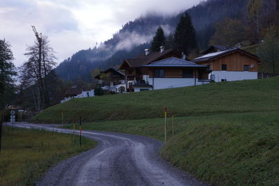 Houses on field against sky