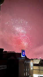 Low angle view of fireworks against sky at night