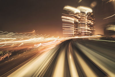 Low angle view of light trails at night