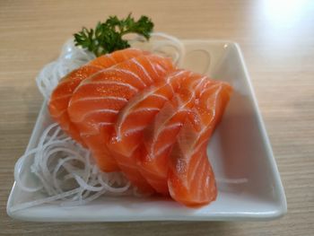 Close-up of chopped fish in plate on table