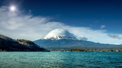 Scenic view of snowcapped mountains against blue sky