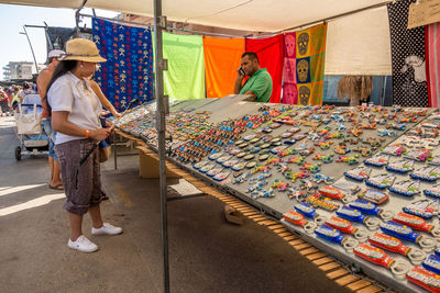 Group of people standing at market stall