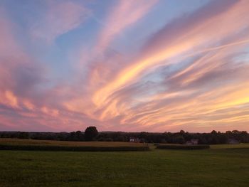 Scenic view of field against sky during sunset