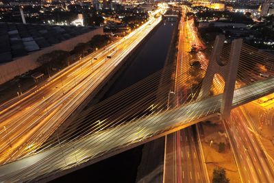 High angle view of light trails on road in city at night