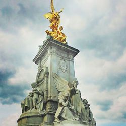 Low angle view of statue against cloudy sky