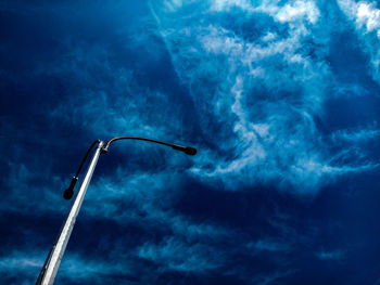 Low angle view of airplane flying against blue sky