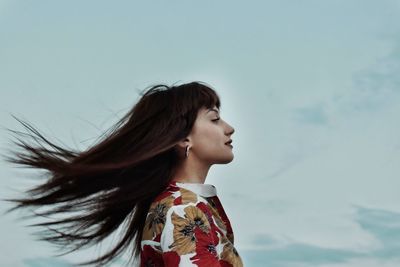 Portrait of woman standing against sky