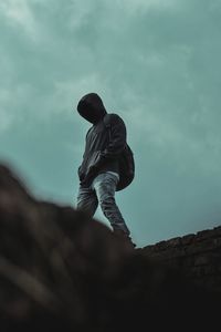 Low angle view of a man walking from above a foundation