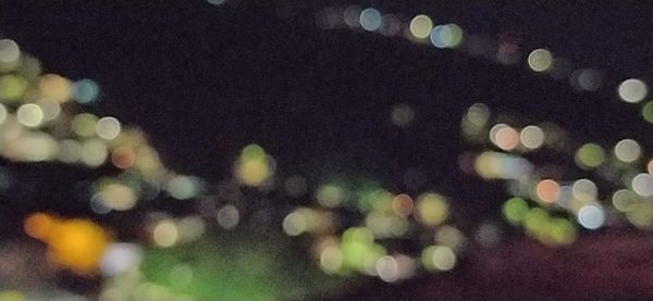 Defocused image of illuminated plants at night