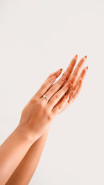 Low section of woman against white background