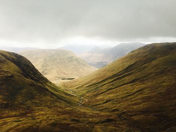 Scenic view of mountains against cloudy sky