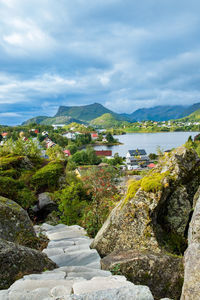 High angle view of townscape by sea against sky