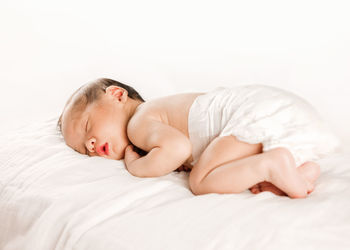 Baby girl sleeping on bed