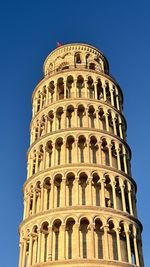 Low angle view of building against clear blue sky