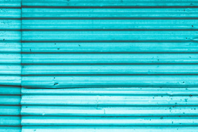 Full frame shot of blue painted shop metal curtain wall